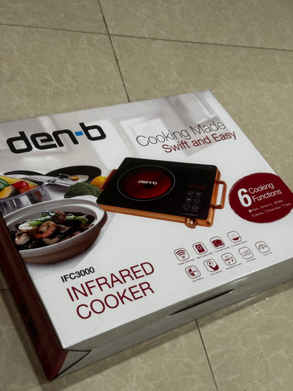 Den-B infrared Infrared Cooker packaging on a tiled floor